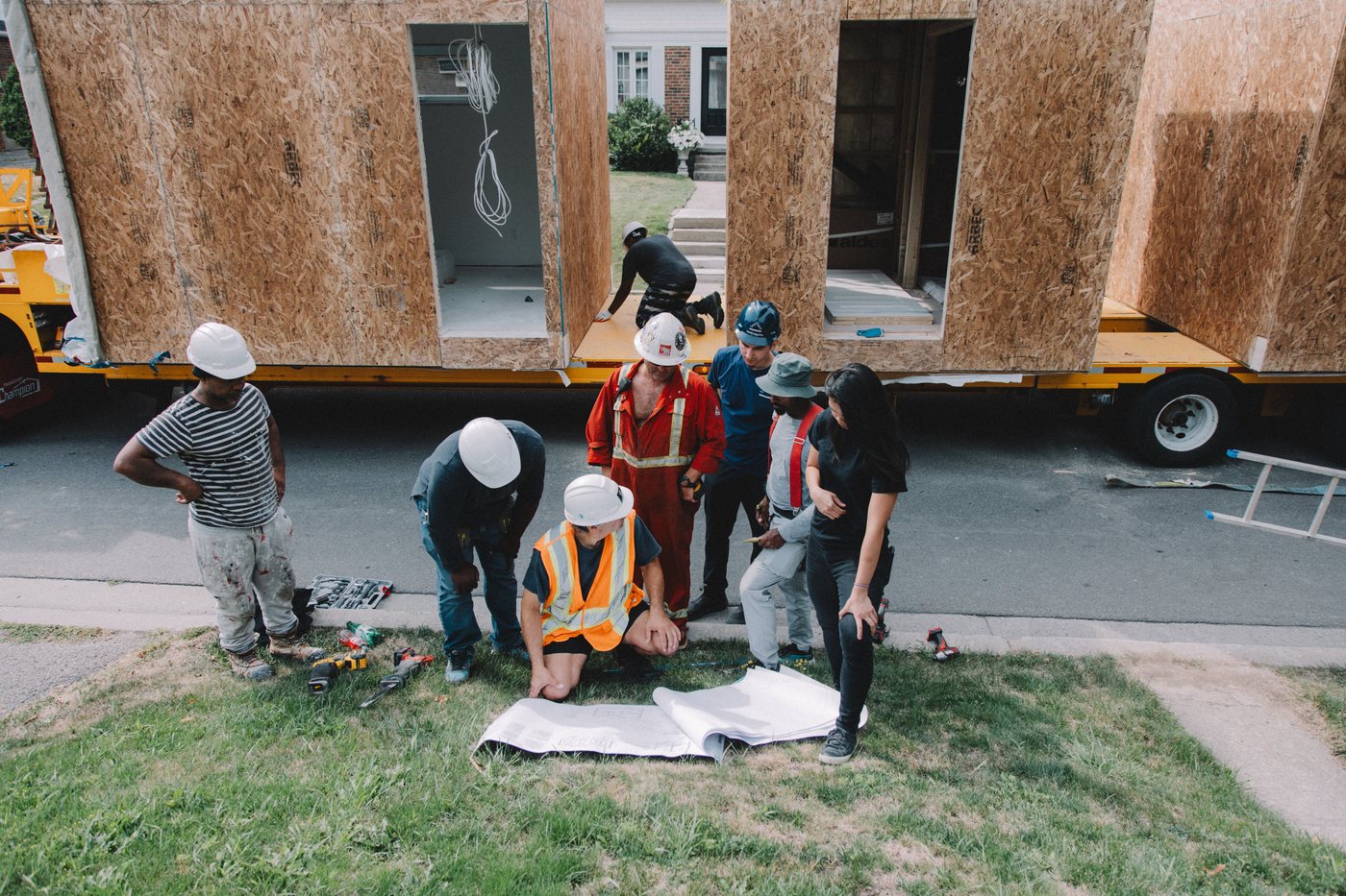 Metrosuite and the site crew reviewing drawings beside the modules on Anndale Drive, North York