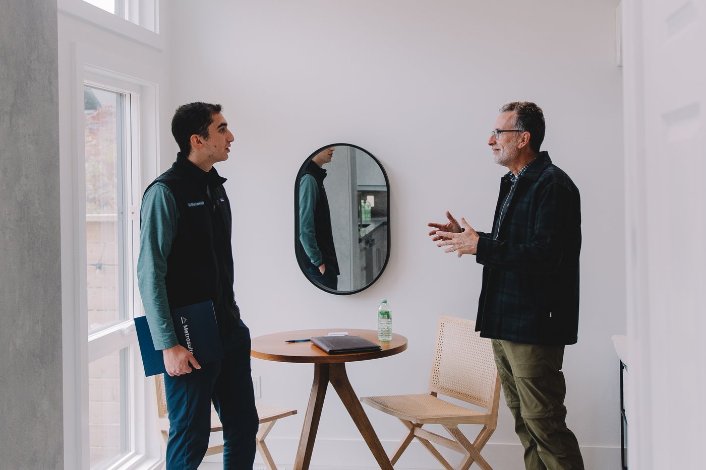 Showing a visitor through the finished garden suite at the Beresford Avenue open house, Toronto, 2024.